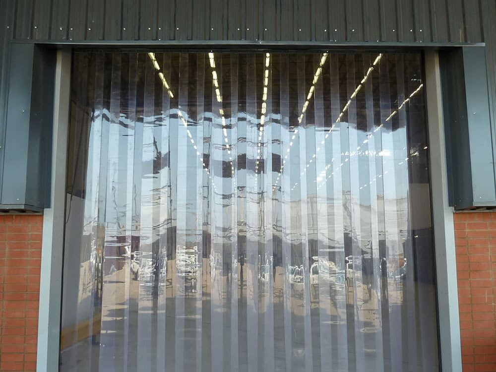 PVC strip curtain hanging in a warehouse loading bay opening
